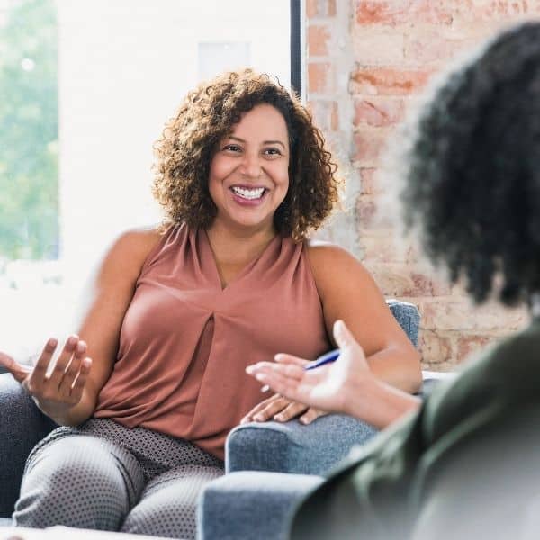 Woman conducting a 1:1 wellness coaching session in person